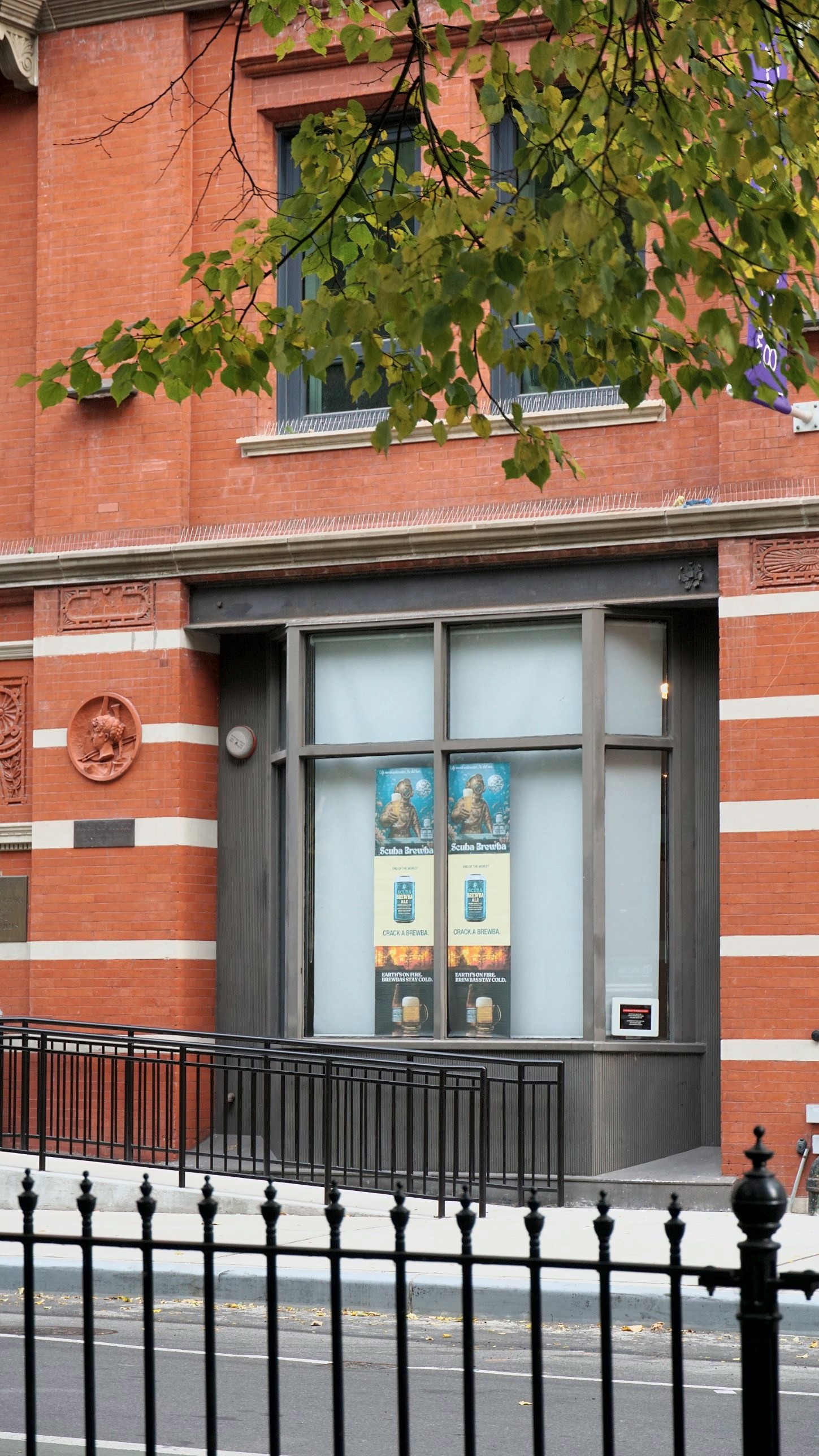 Close view of the gallery window with two columns of Scuba Brewba posters