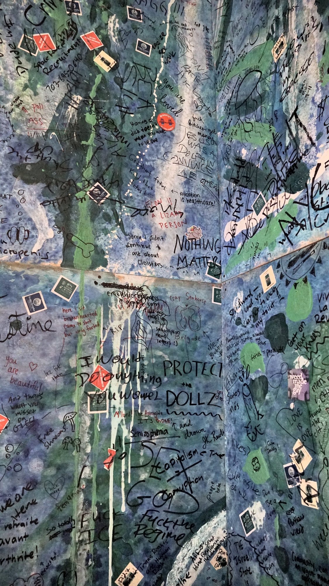Corner of the club bathroom walls, floor to ceiling graffiti